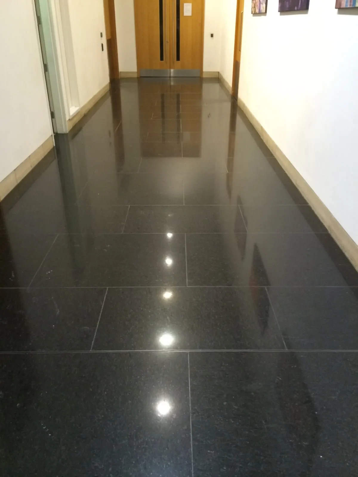 Black granite corridor after high polishing