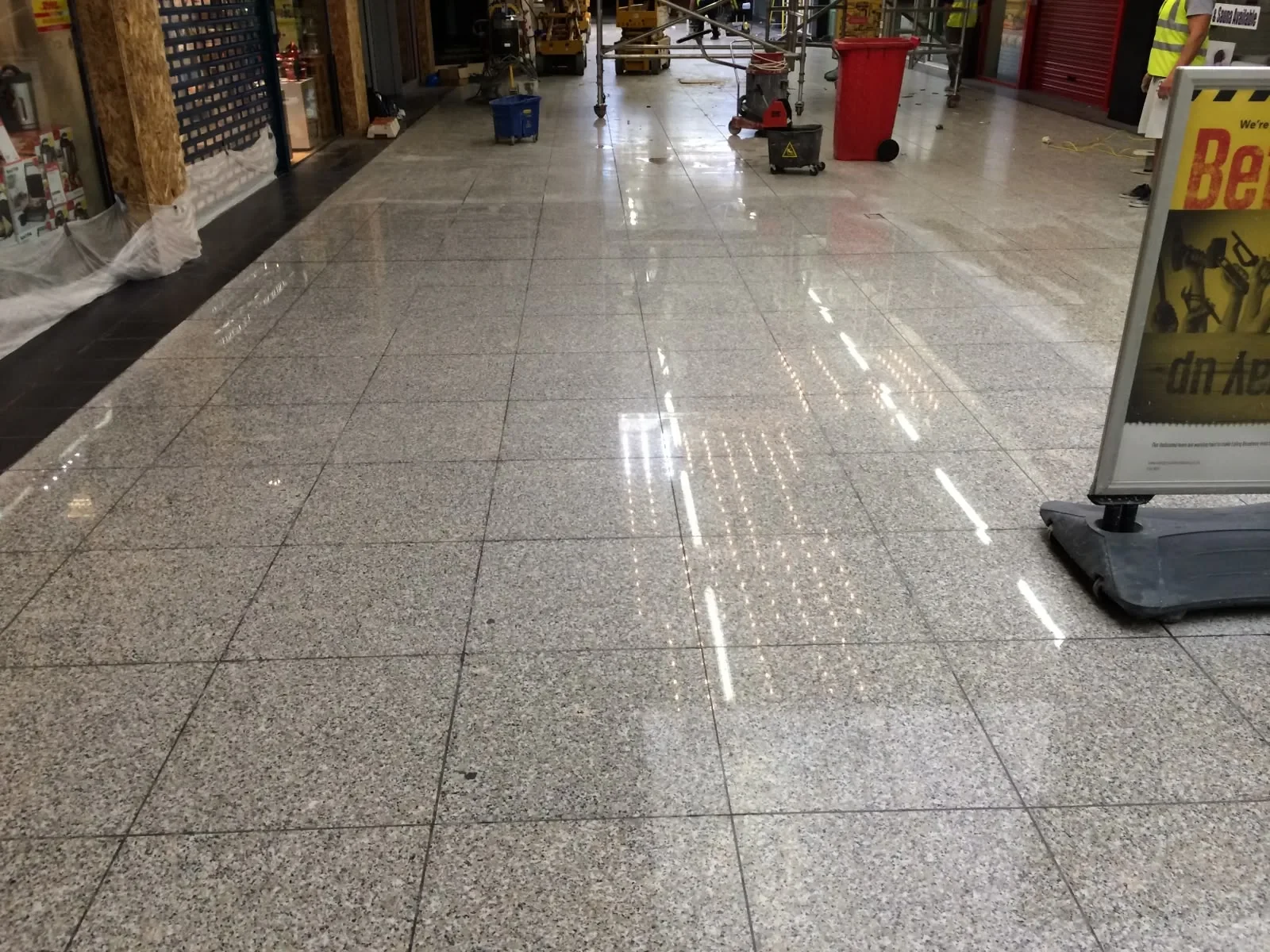 Commercial granite walkway showing polished and untreated stone in one frame